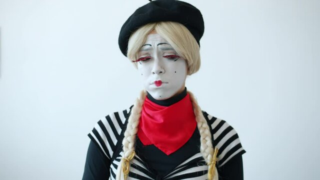 Slow motion portrait of upset girl mime sobbing and crying flapping arms standing alone on white background. Negative emotions and people concept.