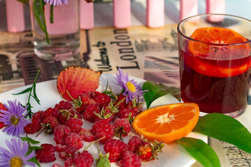 Lingonberry juice, raspberries, orange slice. 