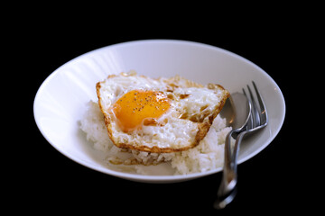 egg fried topping on rice isolated on black background