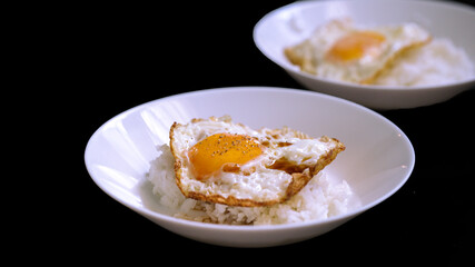 egg fried topping on rice isolated on black background