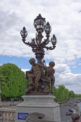 Fototapeta na wymiar Candelabr surrounded by statues of children called Les Amours, and in English this translates to The Loves,sculpted by Henri Desire Gauquie