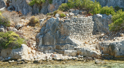 Fototapeta na wymiar Kekova is an island that under the water preserves the ruins of 4 ancient cities,that left the water in the II century BC. in because of the earthquake