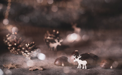 Christmas decorations -  white wooden rain deers, pinecones and bokeh background