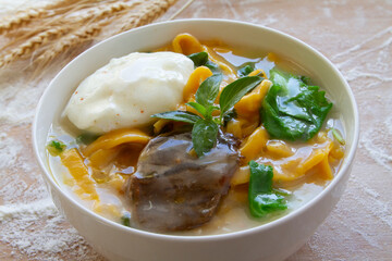 Corn noodles with eggs and beef close up.