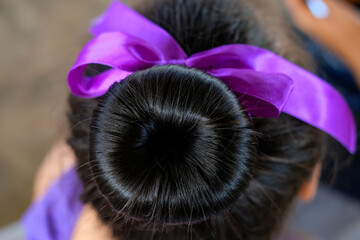 Close up hair bun of ballet girl with blur ribbon use for beauty and fashion background