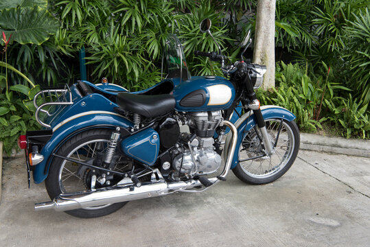 Motorcycle blue in the parking lot in the jungle. Thailand, 2017