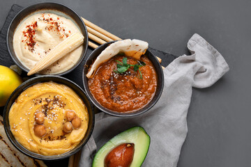 Different kinds of hummus dips with snacks