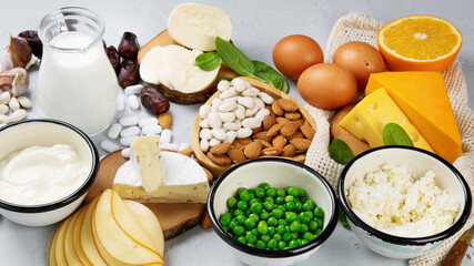 Healthy diary and non-diary products rich in calcium on grey background