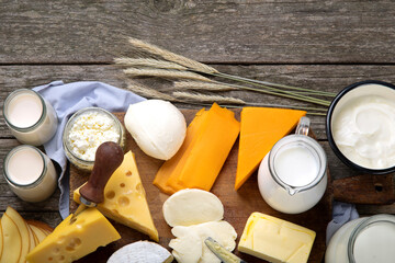 Different types of fresh dairy products on wooden background