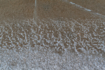 The frozen river bank. Winter background. Ice close-up.