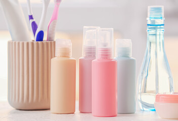 Travel cosmetics kit on table against blurred background