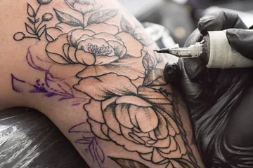 Fotobehang Professional artist making tattoo in salon © Pixel-Shot
