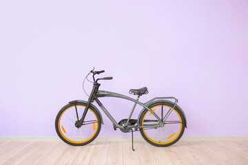 Obraz na płótnie Canvas Modern bicycle against color wall