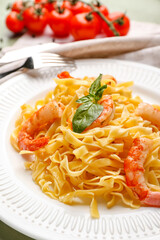Plate of tasty pasta with shrimps on table