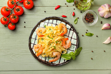 Plate of tasty pasta with shrimps on table