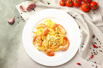Plate of tasty pasta with shrimps on table