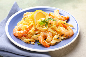 Plate of tasty pasta with shrimps on table