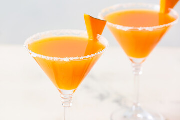 Glass of tasty pumpkin pie martini on table, closeup