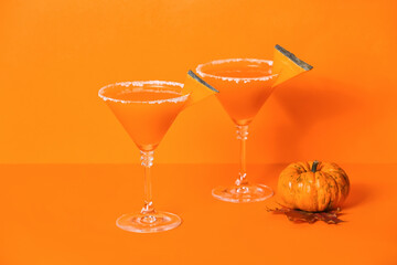 Glasses of tasty pumpkin pie martini on color background