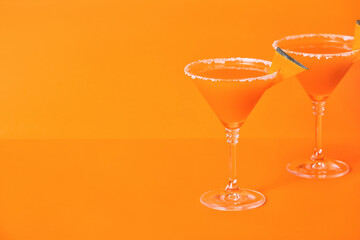 Glasses of tasty pumpkin pie martini on color background