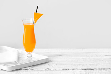 Glass of tasty pumpkin pie martini on table