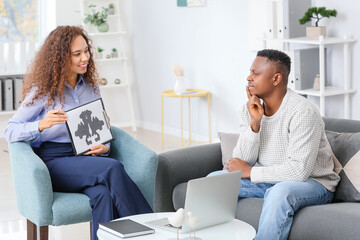 Psychologist working with African-American man in office