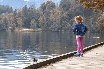 Fototapeta na wymiar Little lonely girl in anxious emotion outdoors.