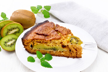 Pie with kiwi in plate on board