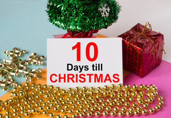 Christmas tree decorated with toys and tinsel, gift boxes and greeting card with text 10 Days till...