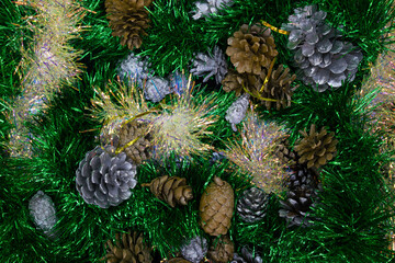 Bright cones painted in silver and gold among green and flying tinsel.