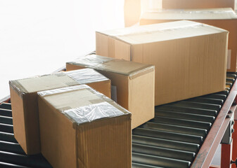 Shipment boxes. Packaging Cardboard boxes sorting on conveyor belt in distribution warehouse.