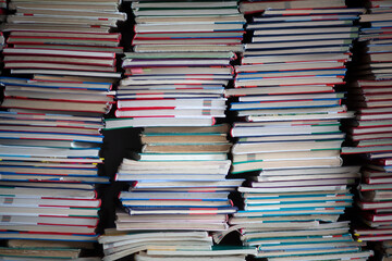  Stacks of old discarded school textbooks waiting to be disposed of in a school library.