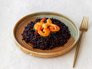 Black rice risotto with shrimp. Sea food. Diet. Healthy eating.