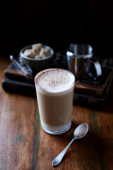 Coffee with milk on dark wooden background. Close up.	
