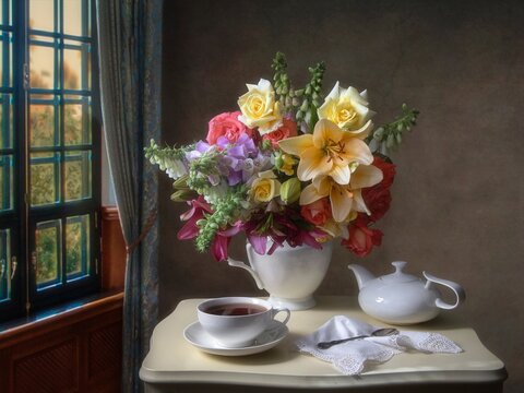 Still life with bouquet of flowers on a tea table