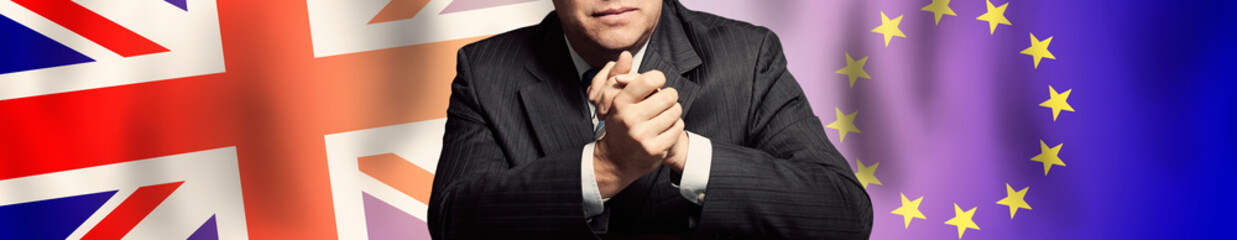Businessman or politics arms against UK and European Union flag background