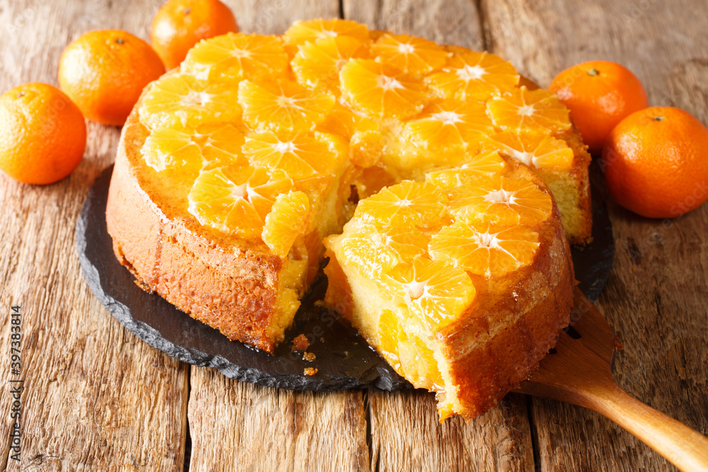 Canvas Prints delicious cut tangerine pie close-up on a slate board on the table. horizontal