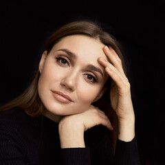 Sexy Female Model Low-key Portrait. Portrait of beautiful caucasian woman in black dress on black background. High quality photo