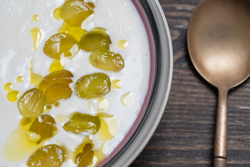 Traditional Spanish dish, cold soup ajo blanco or ajoblanco from garlic, almonds, white wine vinegar, olive oil and grapes