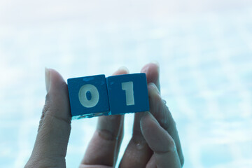 Number zero and one on hand with blue background.