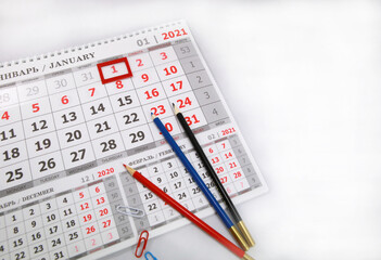 Fototapeta premium Colored pencils lying on a 2021 calendar page