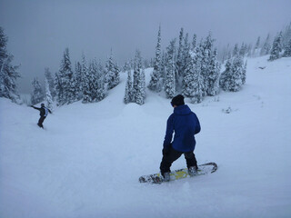 Fototapeta na wymiar Snowboarder on the slopes of a ski resort after a storm