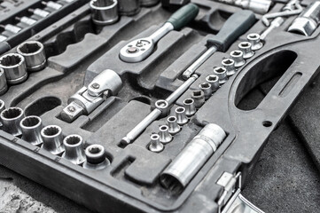 Fototapeta premium Open tool box, set of keys and bits. Dirty set of tools during work. Selective focus