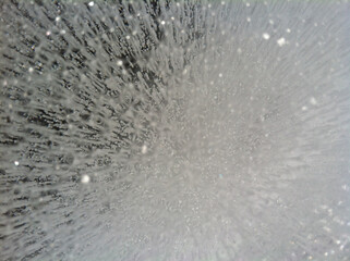Close-up view of trapped ice bubbles under the ice at a frozen lake
