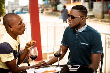 two handsome young people talking near a restaurant