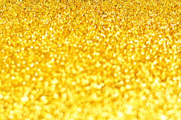 Yellow golden glitter bokeh bright shiny sparkle blur background.  New Year, Christmas and all celebrations background concept. 