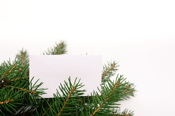 Blank business card with christmas tree branches. New year celebration concept banner. Gift certificate. Side view. Minimalist mockup. Invitation to an event or party. Advertising information