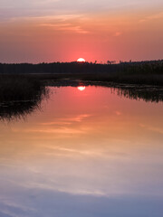 Obraz premium Scenic sunset landscape with water reflections and mood colors at autumn evening in Finland.