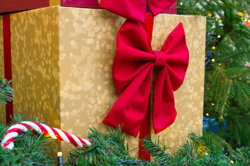 Beautiful colorful gift boxes at the street Christmas market. Christmas and New Year decorations on the festive winter fair. Concept of celebration and presents.