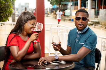 young african couple in a happy refreshment with glasses of wine